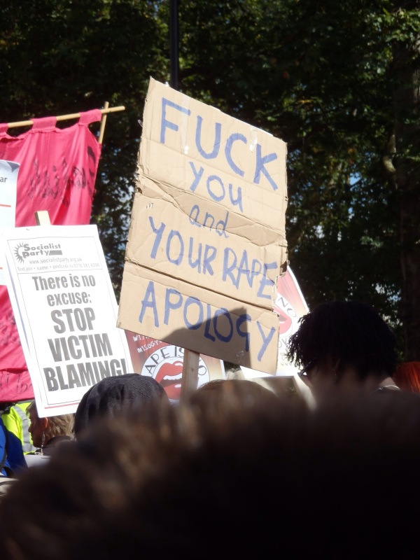 Slutwalk sign "Fuck you and your rape apology" , "There is no excuse: stop victim blaming!"